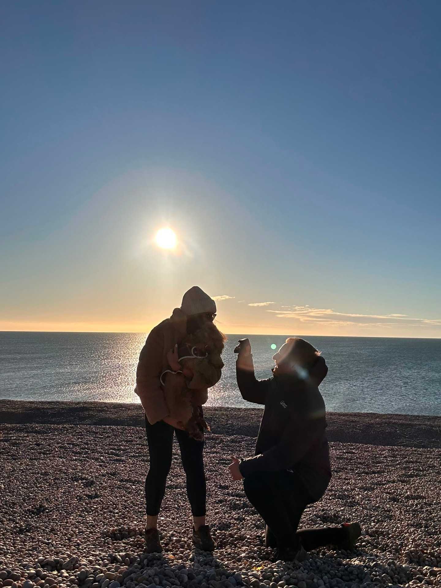 Tim proposing to Sophie on the beach at Weymouth at sunset