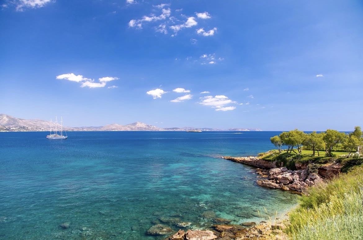 The Island Gallery coastline, turquoise Aegean water and rocky shore